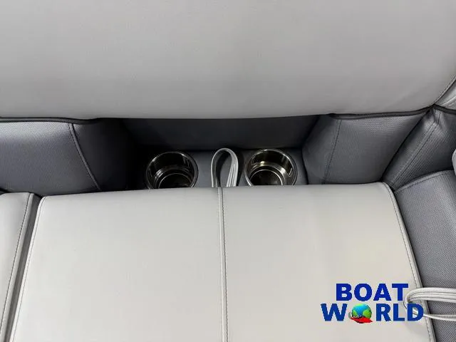 Slide: The Image of 2025 Bentley Pontoons Legacy 200 Navigator interior with cup holders and gray seating. - 27