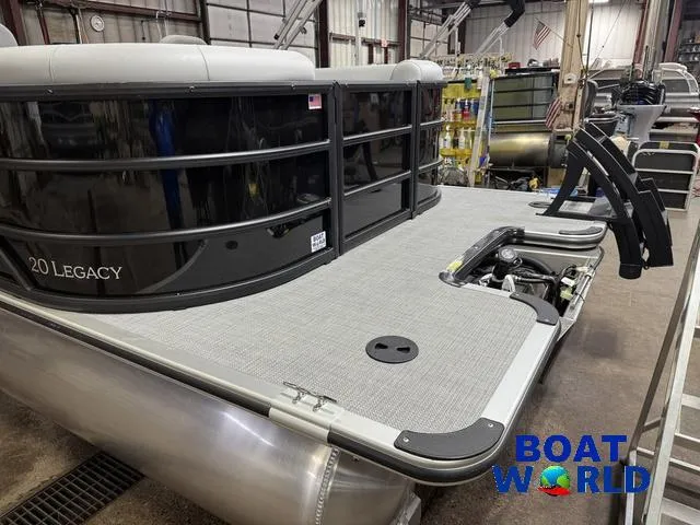 Slide: The Image of 2025 Bentley Pontoons Legacy 200 Navigator Quad Lounge with Honda 4-Stroke engine in a workshop. - 36