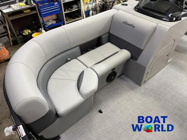 Slide: The Image of 2025 Bentley Pontoons Legacy 200 Navigator Quad Lounge interior with gray seating. - 9