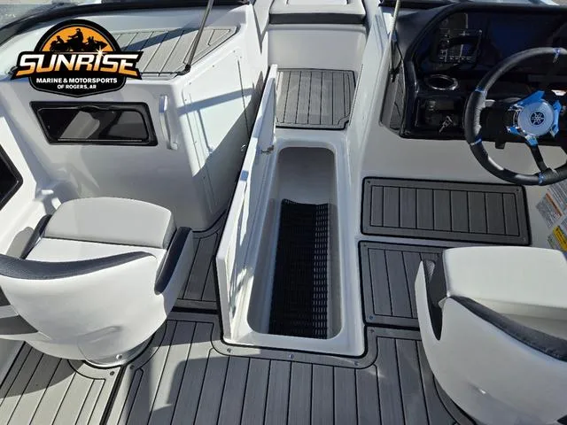 Slide: The Image of 2025 Yamaha Boats 195S interior with open storage compartment and steering wheel, Sunrise Marine logo visible. - 18