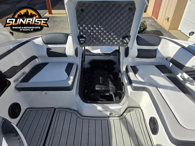 Slide: The Image of 2025 Yamaha Boats 195S interior with open engine compartment, showcasing seating and deck layout. - 19