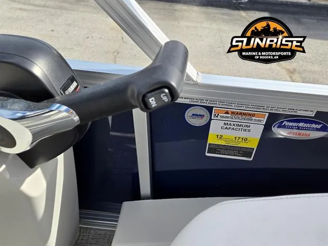 Slide: The Image of 2025 Avalon 21' Venture 85 Platinum Rear Fish boat interior with control lever and capacity labels. - 10