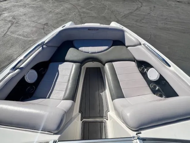 Slide: The Image of 2006 MasterCraft X45 boat interior with gray seating and cup holders. - 17