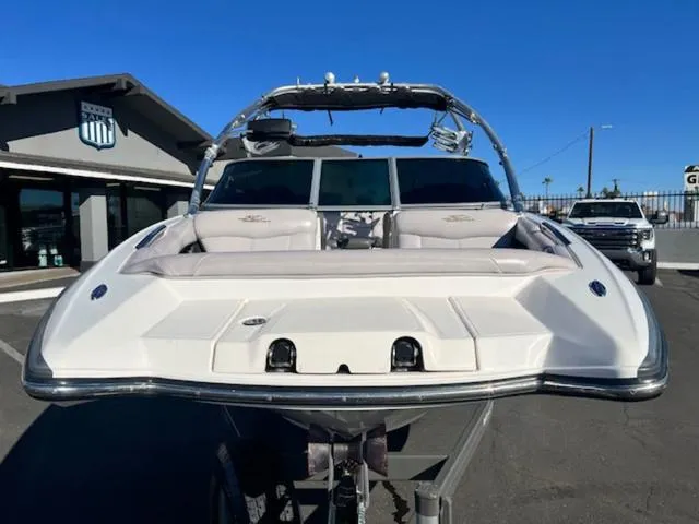 Slide: The Image of 2006 MasterCraft X45 boat with sleek design, parked outdoors under clear blue sky. - 3
