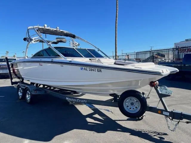 Slide: The Image of 2006 MasterCraft X45 boat on trailer, parked outdoors under clear blue sky. - 4