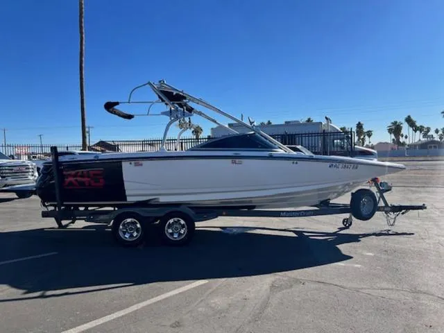 Slide: The Image of 2006 MasterCraft X45 boat on trailer in sunny parking lot. - 5