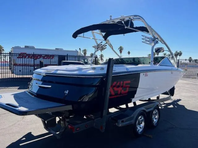 Slide: The Image of 2006 MasterCraft X45 boat on trailer, sunny day, palm trees in background. - 6