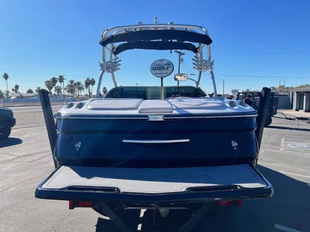 Slide: The Image of 2006 MasterCraft X45 boat, rear view, parked under clear blue sky. - 7