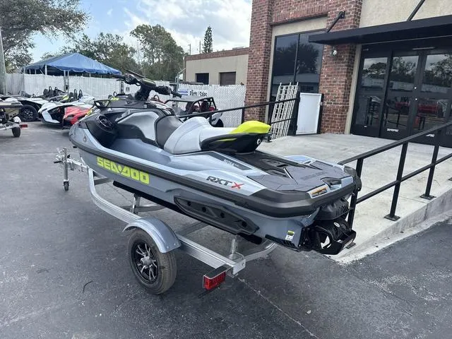 Slide: The Image of 2025 Sea-Doo Waverunner PWC RXT X on trailer, parked outside a building. - 4