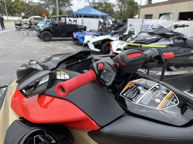 Slide: The Image of 2025 Sea-Doo Waverunner PWC RXP X 325 with red handlebars, parked outdoors. - 4