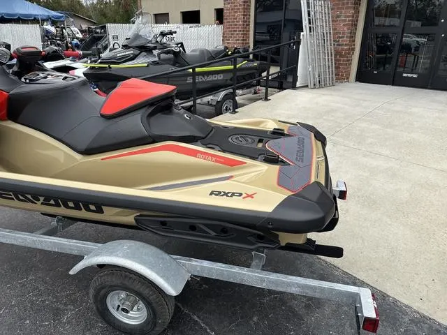 Slide: The Image of 2025 Sea-Doo Waverunner PWC RXP X 325 on trailer, parked outside a store. - 6