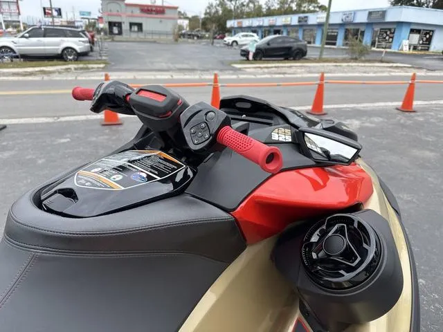 Slide: The Image of 2025 Sea-Doo Waverunner PWC RXP X 325 with red handlebars, parked outdoors. - 9