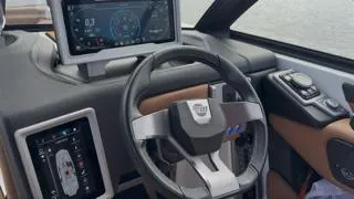 Slide: The Image of 2024 Malibu M242 boat dashboard with modern steering and digital display. - 8