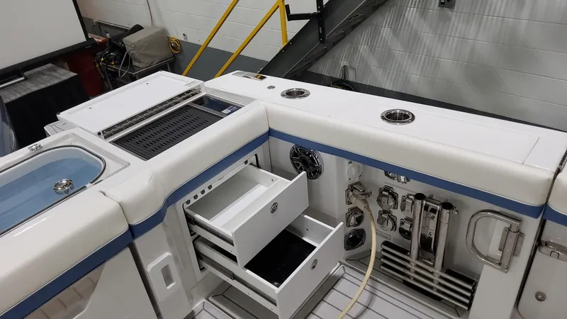 Slide: The Image of 2025 Formula 387 Center Console Fish boat interior with storage and fishing equipment. - 12