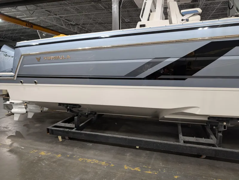 Slide: The Image of 2025 Formula 387 Center Console Fish boat in a showroom setting. - 2