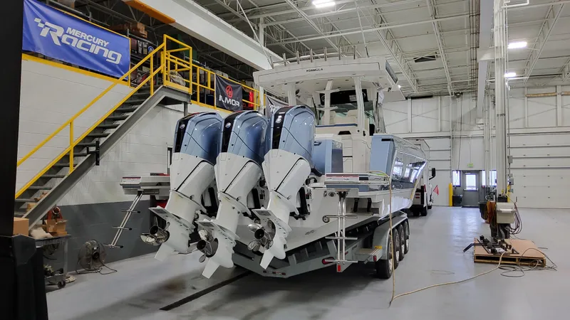 Slide: The Image of 2025 Formula 387 Center Console Fish boat with triple engines in a workshop. - 3