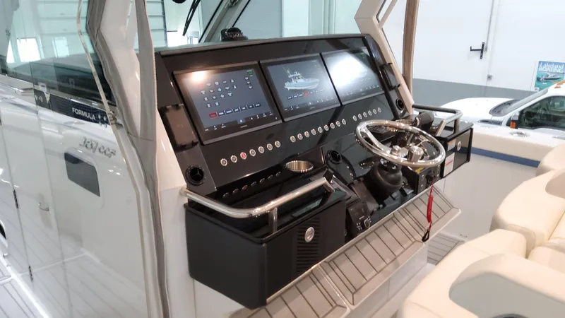 Slide: The Image of 2025 Formula 387 Center Console Fish boat dashboard with advanced navigation displays. - 33