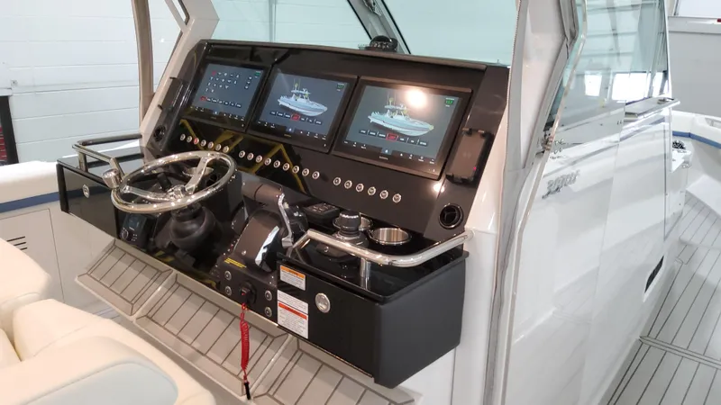 Slide: The Image of 2025 Formula 387 Center Console Fish boat dashboard with advanced navigation screens. - 36