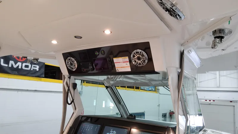 Slide: The Image of 2025 Formula 387 Center Console Fish boat interior with control panel and speakers. - 37