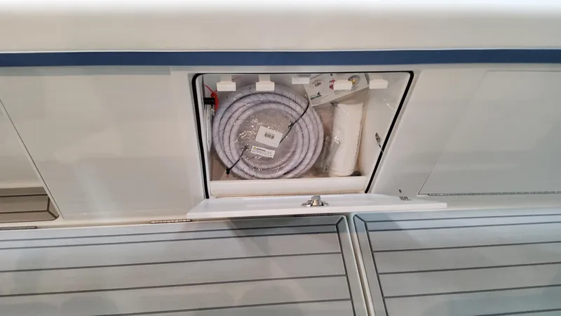 Slide: The Image of 2025 Formula 387 Center Console Fish storage compartment with coiled hose. - 42