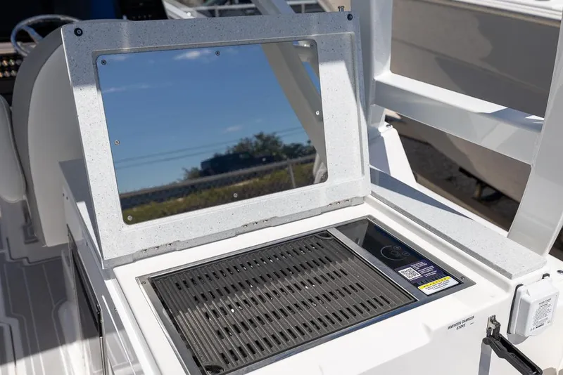 Slide: The Image of Sea Fox 288 Traveler 2025 boat grill and prep station on deck. - 13