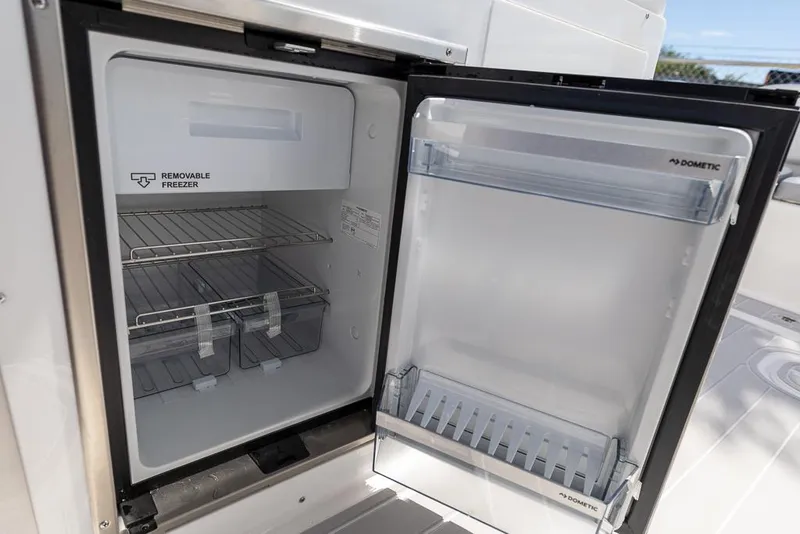 Slide: The Image of Open refrigerator on 2025 Sea Fox 288 Traveler boat, featuring a removable freezer compartment. - 15