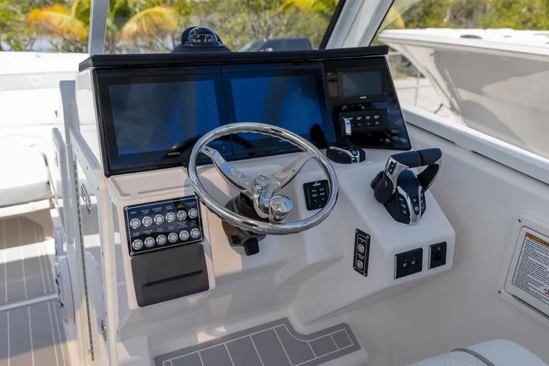 Slide: The Image of 2025 Sea Fox 288 Traveler boat dashboard with steering wheel and control panel. - 19