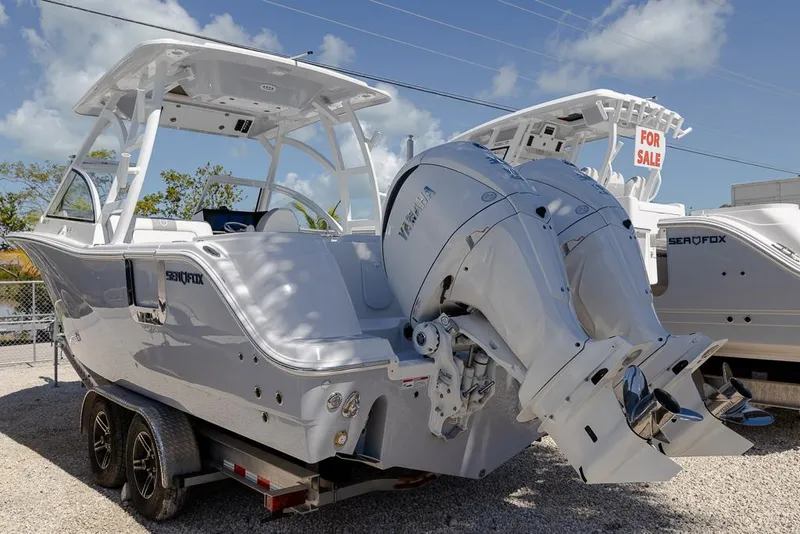 Slide: The Image of 2025 Sea Fox 288 Traveler boat on trailer, for sale, under clear blue sky. - 3