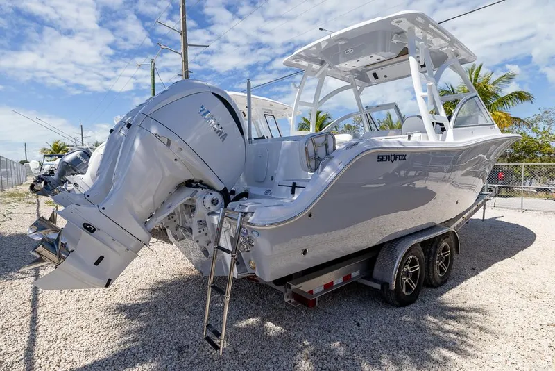 Slide: The Image of 2025 Sea Fox 288 Traveler boat on trailer, featuring dual Yamaha engines. - 6