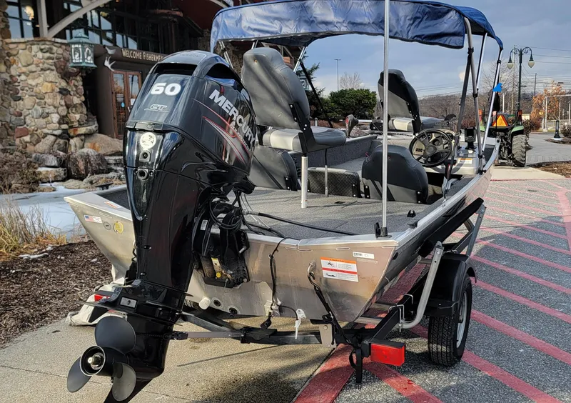 Slide: The Image of 2017 Lowe Stryker 17 boat with Mercury 60 outboard motor, parked on a trailer. - 2