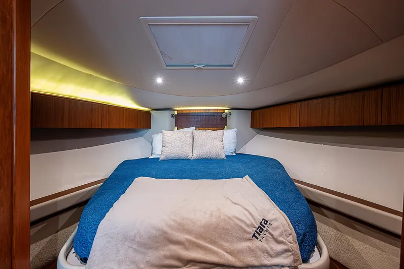 Slide: The Image of 2013 Tiara Yachts 3600 Open cabin with cozy bed and wooden accents. - 12