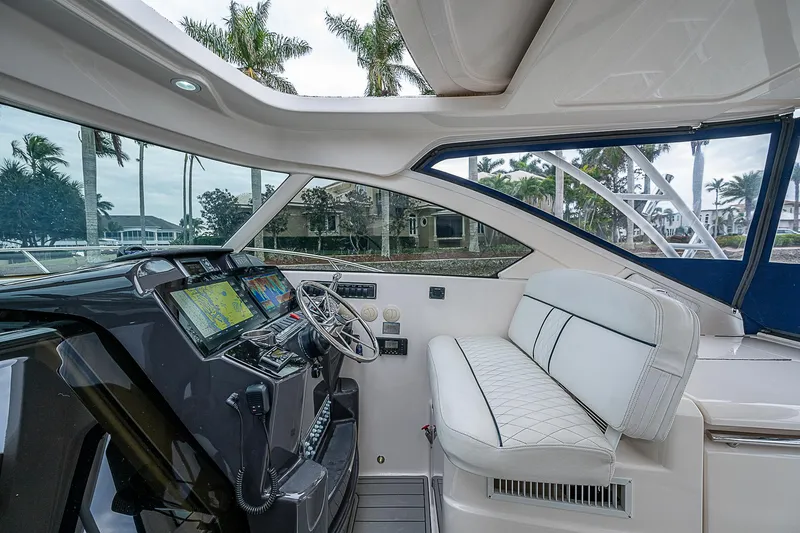 Slide: The Image of 2013 Tiara Yachts 3600 Open helm with modern controls and white seating. - 19