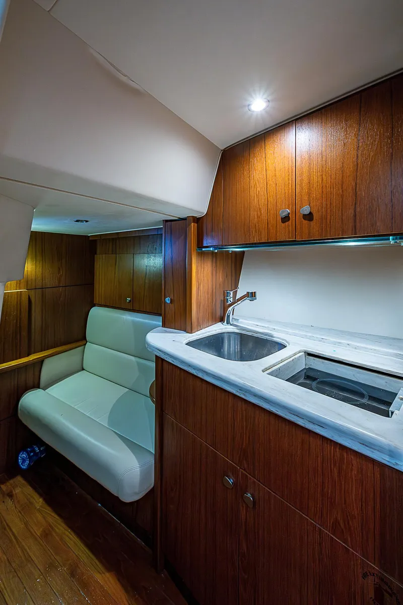 Slide: The Image of 2013 Tiara Yachts 3600 Open interior with wood cabinetry and compact kitchen area. - 22