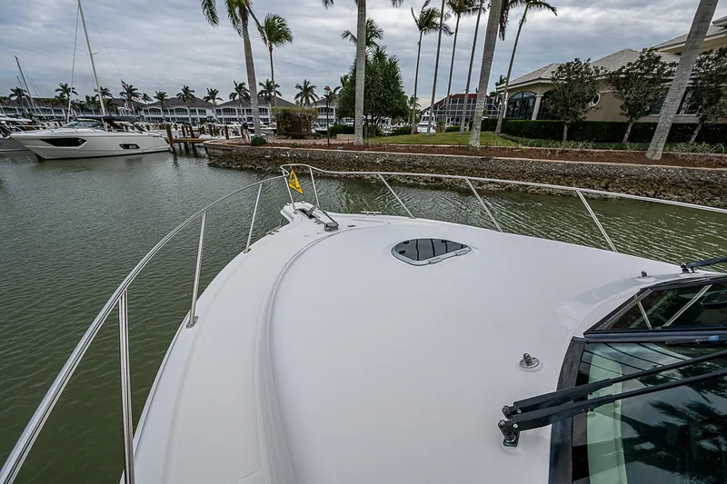 Slide: The Image of 2013 Tiara Yachts 3600 Open docked in a marina with palm trees. - 5