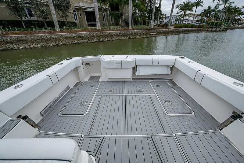 Slide: The Image of 2013 Tiara Yachts 3600 Open boat deck with sleek gray flooring, docked by a waterfront. - 7