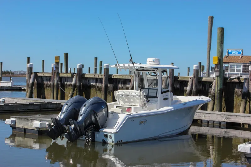 The Image of 2023 Sea Hunt Gamefish 27 boat docked, featuring twin engines and a coffin box. - 0