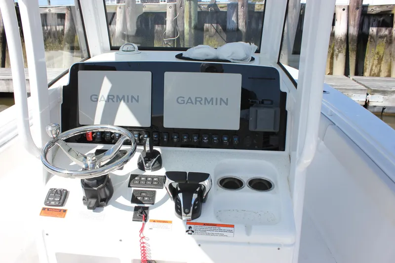 Slide: The Image of 2023 Sea Hunt Gamefish 27 dashboard with Garmin displays and steering wheel. - 15