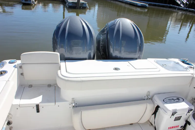 Slide: The Image of 2023 Sea Hunt Gamefish 27 boat with twin engines and coffin box, docked in marina. - 17