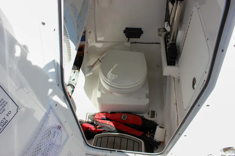 Slide: The Image of 2023 Sea Hunt Gamefish 27 interior with toilet and storage area. - 22