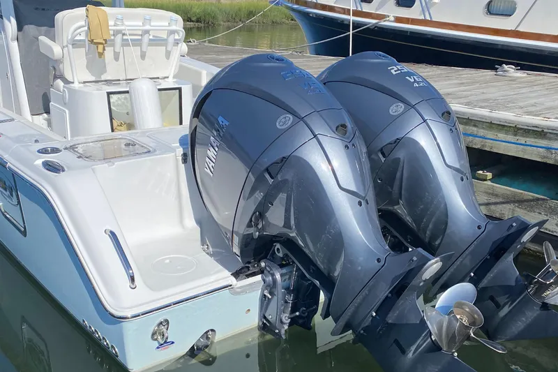 Slide: The Image of 2023 Sea Hunt Gamefish 27 with twin outboard motors docked. - 25