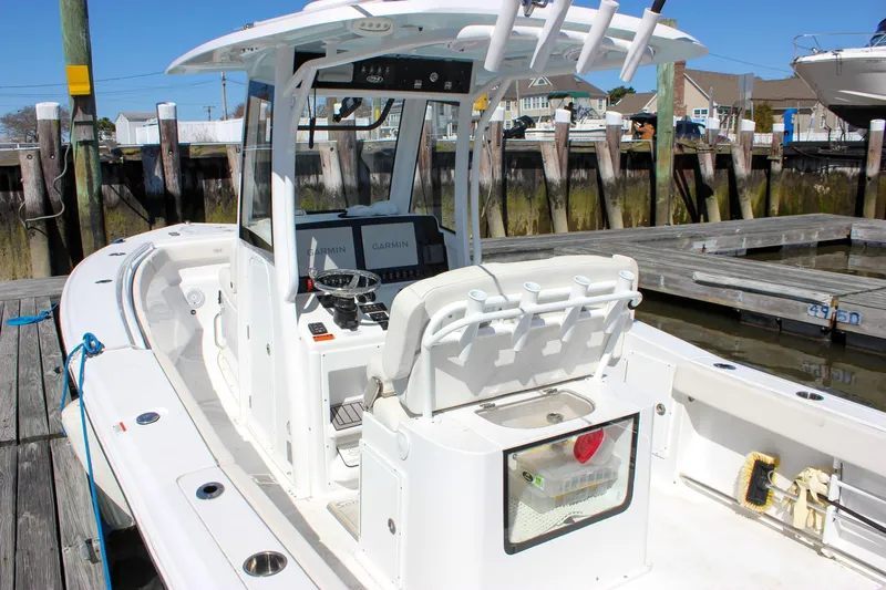 Slide: The Image of 2023 Sea Hunt Gamefish 27 with Coffin Box, docked at a marina. - 6