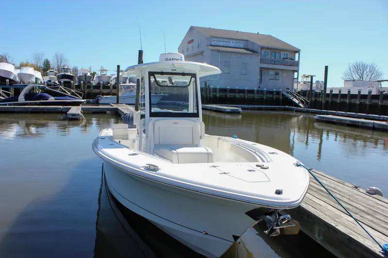 Slide: The Image of 2023 Sea Hunt Gamefish 27 with Coffin Box docked at a marina. - 7