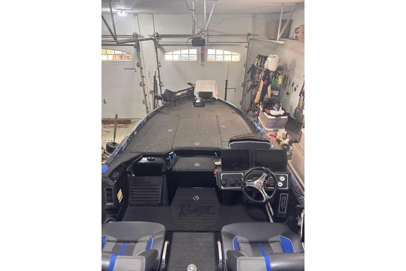 Slide: The Image of 2025 Ranger Z520 boat interior in a garage, featuring steering wheel and storage compartments. - 89