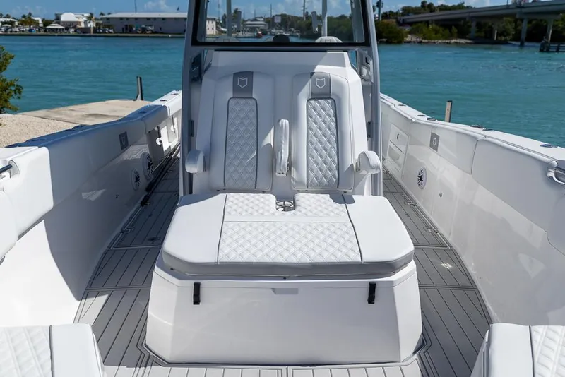Slide: The Image of 2025 Sea Fox 328 Commander boat interior with luxurious seating and ocean backdrop. - 22