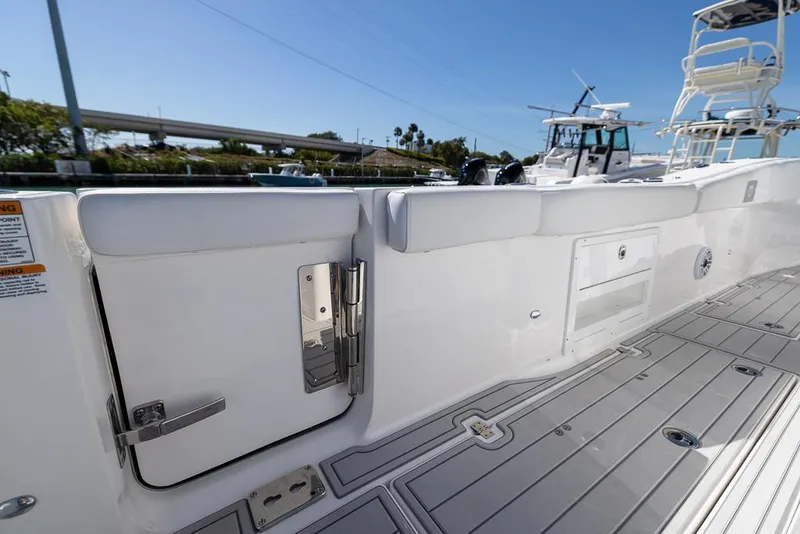 Slide: The Image of 2025 Sea Fox 328 Commander boat deck with storage compartments and sleek design. - 23