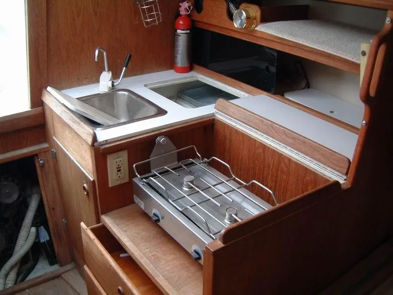 Slide: The Image of Compact kitchen area in a 1987 Abbott 33 sailboat with sink and stove. - 13