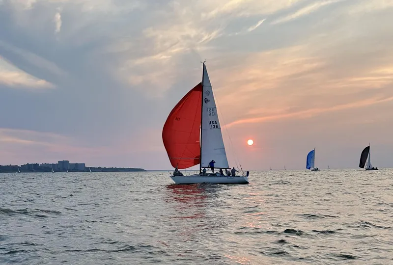 Slide: The Image of Sailboat with red sail on calm water at sunset, Abbott 33 model, 1987. - 6
