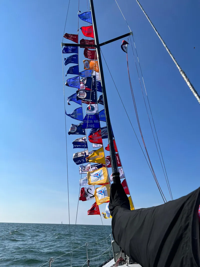Slide: The Image of Sailboat mast with colorful flags against clear blue sky, Abbott 33, 1987 model. - 7