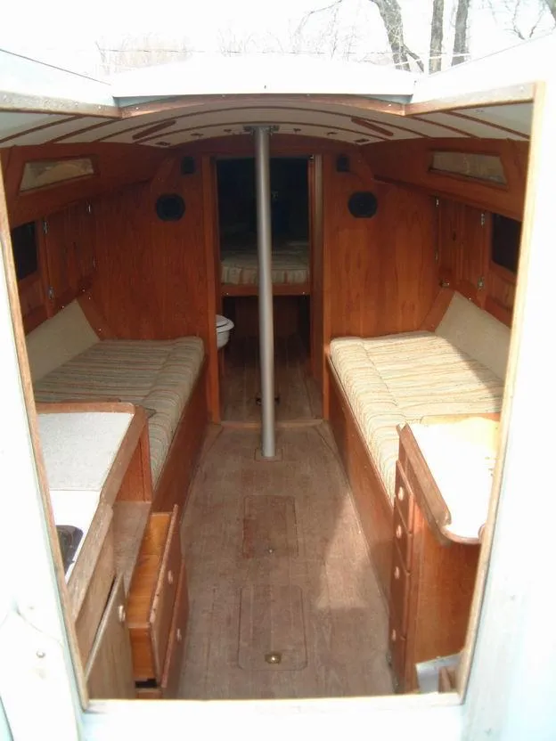 Slide: The Image of Interior of a 1987 Abbott 33 sailboat, featuring wooden furnishings and cozy seating. - 8