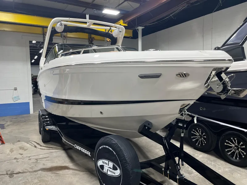 Slide: The Image of 2025 Chaparral 267 SSX boat interior with tan seating and modern dashboard. - 1